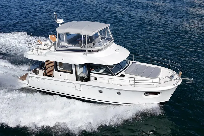 Slide: The Image of 2025 Beneteau Swift Trawler 41 cruising on open water, showcasing sleek design and performance. - 59