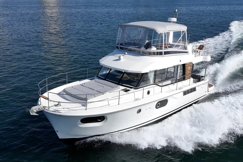 Slide: The Image of 2025 Beneteau Swift Trawler 41 cruising on open water, showcasing sleek design and performance. - 63