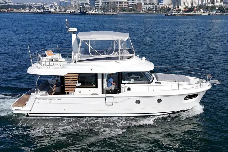 Slide: The Image of 2025 Beneteau Swift Trawler 41 cruising on open water, showcasing sleek design and modern features. - 67