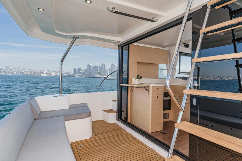 Slide: The Image of 2025 Beneteau Swift Trawler 41 interior with city skyline view, featuring modern design. - 7