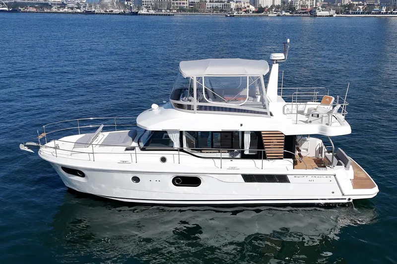 Slide: The Image of 2025 Beneteau Swift Trawler 41 cruising on calm blue waters. - 72
