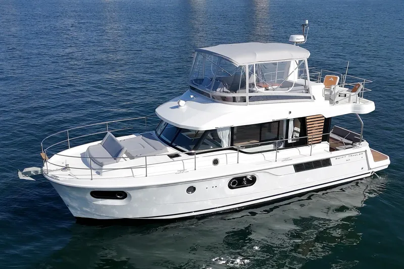 Slide: The Image of 2025 Beneteau Swift Trawler 41 cruising on calm blue waters. - 73
