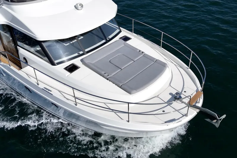 Slide: The Image of 2025 Beneteau Swift Trawler 41 cruising on water, showcasing sleek design and spacious deck. - 78