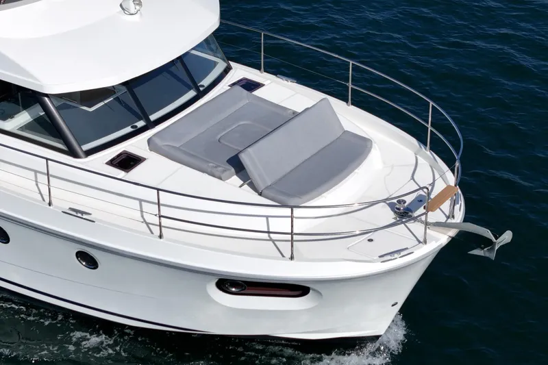 Slide: The Image of 2025 Beneteau Swift Trawler 41 cruising on open water, showcasing sleek design and spacious deck. - 79