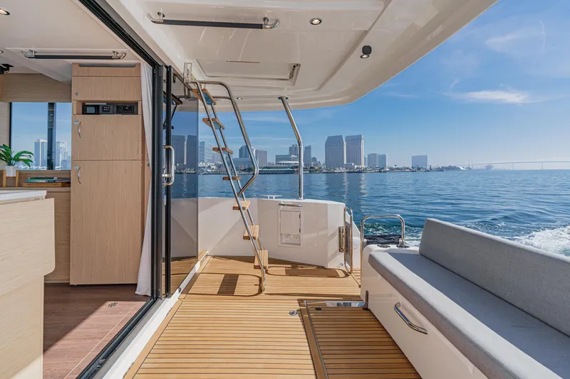 Slide: The Image of 2025 Beneteau Swift Trawler 41 interior with city skyline view. - 9