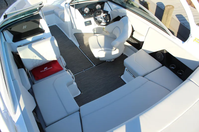 Slide: The Image of 2026 Four Winns H2 Freedom boat interior with luxurious seating and modern dashboard. - 10
