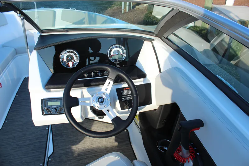 Slide: The Image of 2026 Four Winns H2 Freedom boat dashboard with steering wheel and control panel. - 17