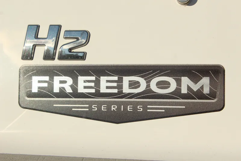 Slide: The Image of 2026 Four Winns H2 Freedom Series logo on boat exterior. - 24