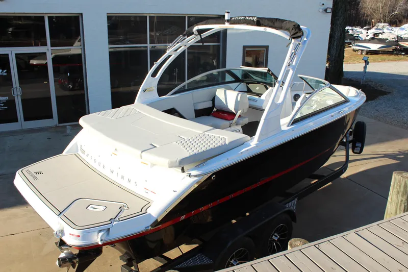 Slide: The Image of 2026 Four Winns H2 Freedom boat on trailer, sleek design, white and black exterior. - 3