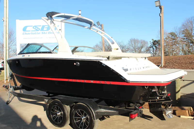 Slide: The Image of 2026 Four Winns H2 Freedom boat on trailer at Charlotte Ski Boats dealership. - 5