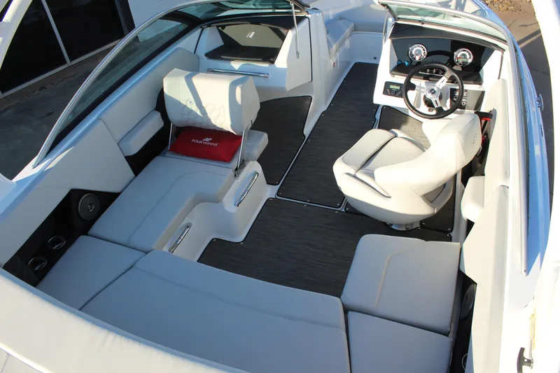 Slide: The Image of 2026 Four Winns H2 Freedom boat interior with modern seating and steering console. - 9
