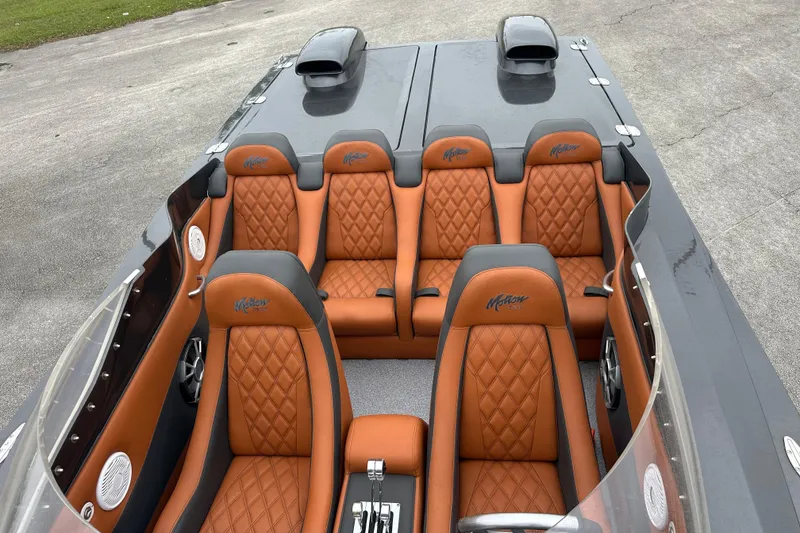 Slide: The Image of 2008 Motion Marine 35 XP boat interior with orange diamond-stitched seats and sleek design. - 12