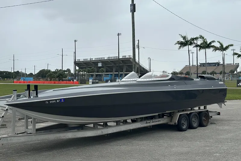 Slide: The Image of 2008 Motion Marine 35 XP boat on trailer, overcast sky. - 9