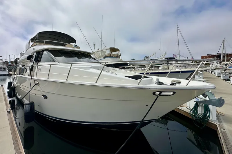 Slide: The Image of 2004 Meridian 580 Pilothouse yacht docked at marina under cloudy sky. - 10