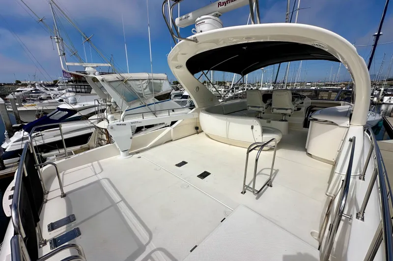 Slide: The Image of 2004 Meridian 580 Pilothouse yacht with spacious deck and seating at marina. - 113