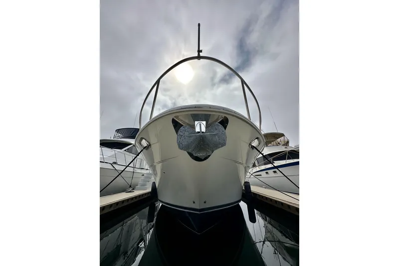 Slide: The Image of Front view of a 2004 Meridian 580 Pilothouse yacht docked under cloudy skies. - 12