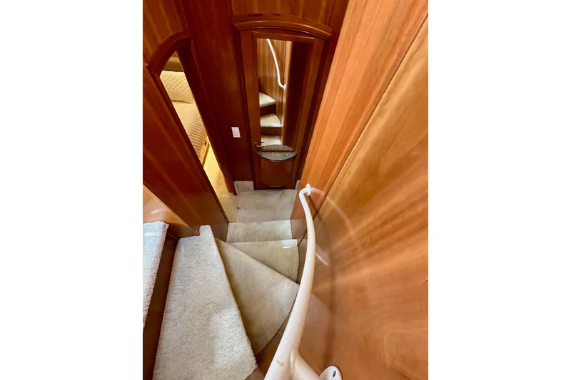 Slide: The Image of Staircase inside 2004 Meridian 580 Pilothouse yacht with wooden paneling and carpeted steps. - 127