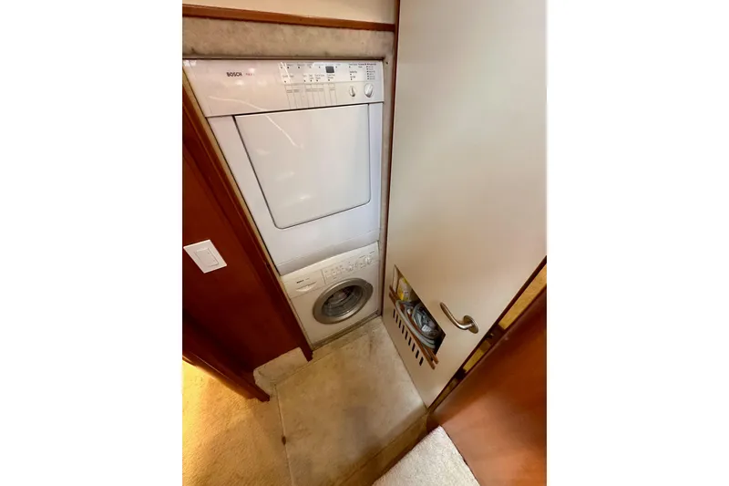 Slide: The Image of Laundry area with Bosch washer-dryer in 2004 Meridian 580 Pilothouse yacht. - 129