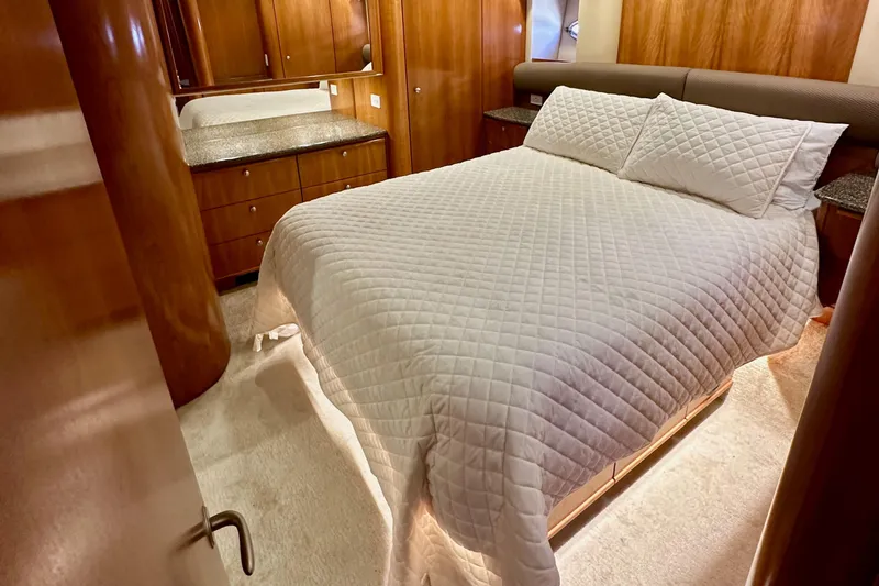 Slide: The Image of Luxurious bedroom interior of 2004 Meridian 580 Pilothouse yacht with wood cabinetry. - 130