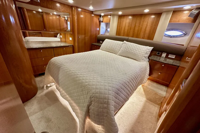Slide: The Image of Luxurious bedroom interior of 2004 Meridian 580 Pilothouse yacht with wood paneling and cozy bedding. - 131