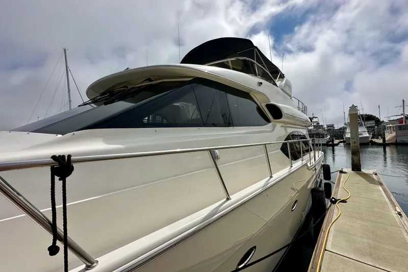 Slide: The Image of 2004 Meridian 580 Pilothouse yacht docked at marina under cloudy sky. - 14