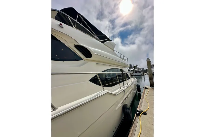 Slide: The Image of 2004 Meridian 580 Pilothouse yacht docked under a cloudy sky. - 15