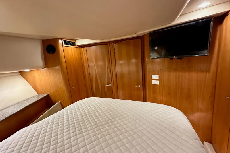 Slide: The Image of Luxurious cabin interior of 2004 Meridian 580 Pilothouse yacht with wood paneling and TV. - 150