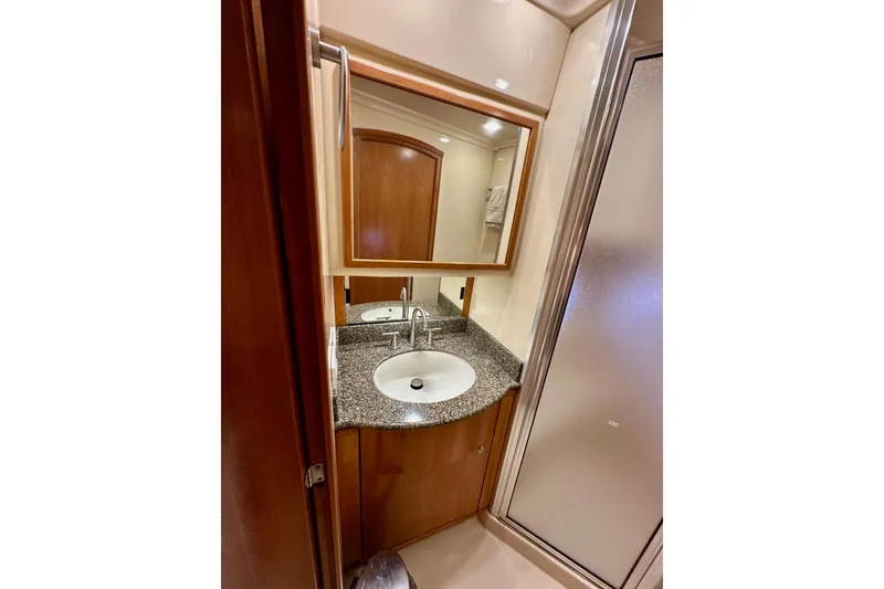 Slide: The Image of 2004 Meridian 580 Pilothouse bathroom with granite countertop and modern fixtures. - 154
