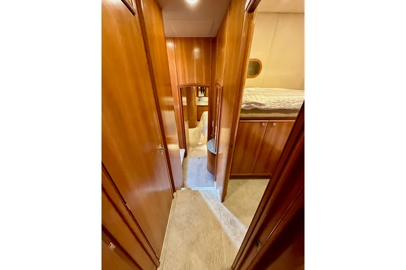 Slide: The Image of Luxurious interior hallway of 2004 Meridian 580 Pilothouse yacht with wood paneling. - 157