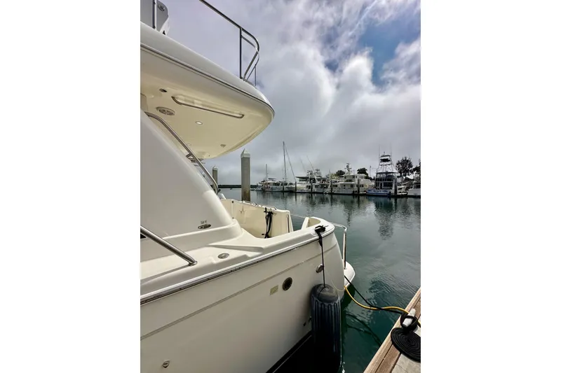 Slide: The Image of 2004 Meridian 580 Pilothouse yacht docked in a serene marina setting. - 16