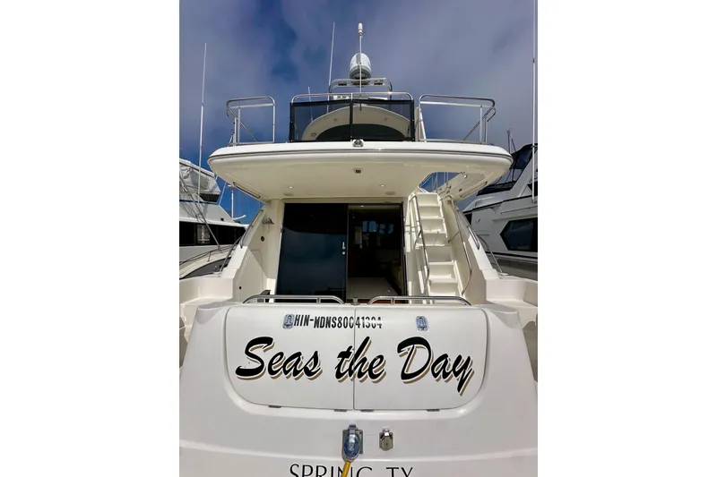 Slide: The Image of 2004 Meridian 580 Pilothouse yacht, "Seas the Day," docked under a clear sky. - 18