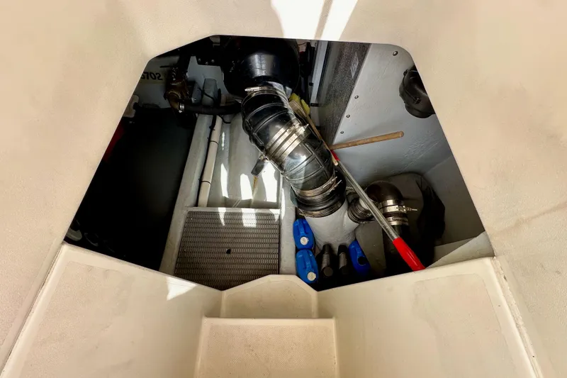 Slide: The Image of Engine compartment of 2004 Meridian 580 Pilothouse yacht, showing mechanical components and piping. - 26