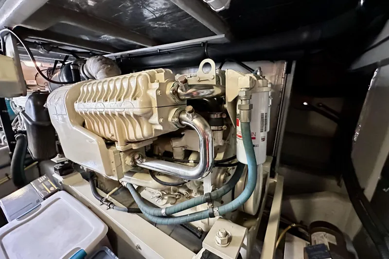 Slide: The Image of Engine room of 2004 Meridian 580 Pilothouse yacht, showcasing detailed machinery components. - 38