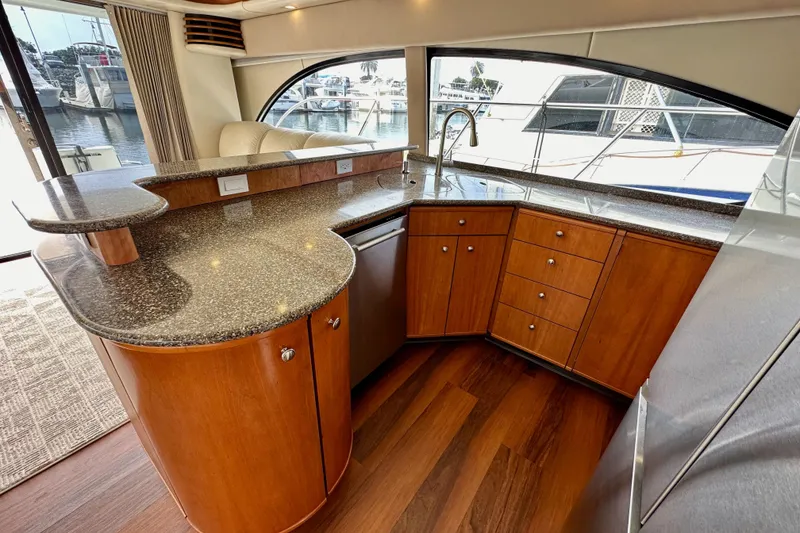 Slide: The Image of Luxurious 2004 Meridian 580 Pilothouse yacht interior with modern kitchen and elegant wood cabinetry. - 48