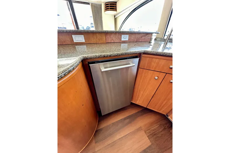 Slide: The Image of Luxurious 2004 Meridian 580 Pilothouse kitchen with modern appliances and elegant wood cabinetry. - 49