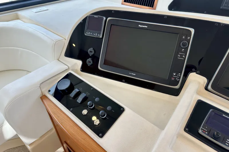 Slide: The Image of 2004 Meridian 580 Pilothouse helm with Raymarine navigation system and control panel. - 57