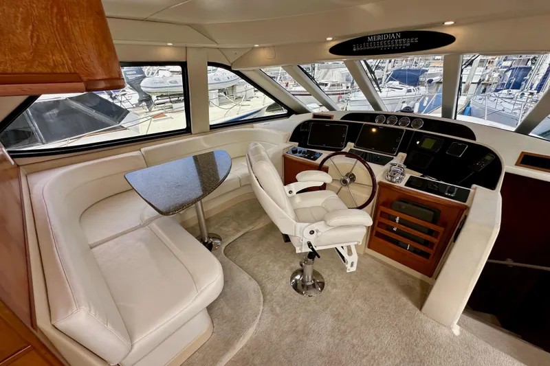 Slide: The Image of Luxurious 2004 Meridian 580 Pilothouse interior with helm, seating, and panoramic windows. - 87