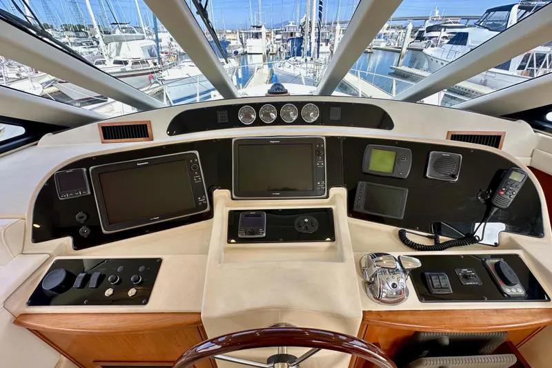 Slide: The Image of Pilothouse of 2004 Meridian 580 yacht with navigation equipment and marina view. - 89