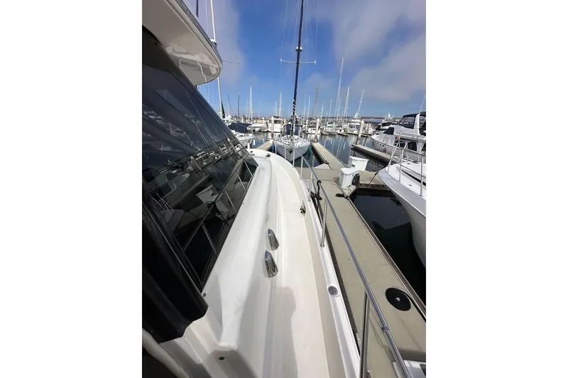 Slide: The Image of 2004 Meridian 580 Pilothouse yacht docked at a marina under a clear sky. - 98