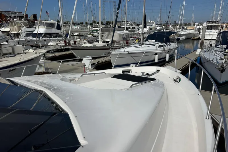 Slide: The Image of 2004 Meridian 580 Pilothouse yacht docked in a marina with other boats. - 99