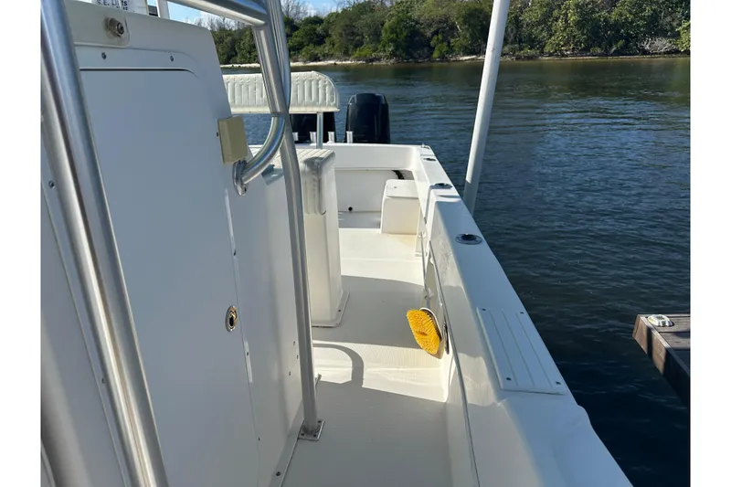 Slide: The Image of 2008 Dusky 278 Center Console boat docked by a serene waterway. - 19