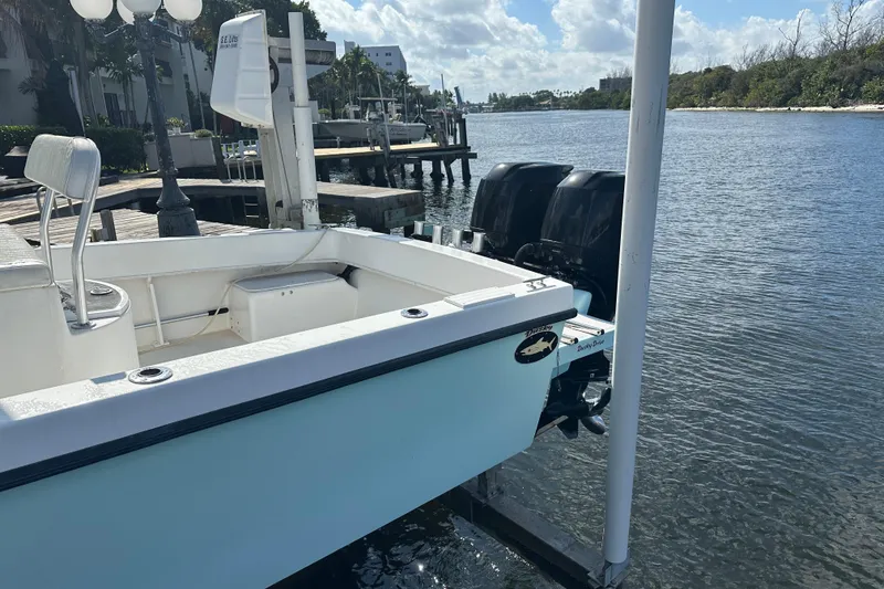 Slide: The Image of 2008 Dusky 278 Center Console boat docked by a scenic waterfront. - 26