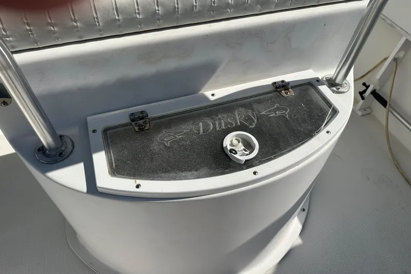 Slide: The Image of 2008 Dusky 278 Center Console boat console with logo and storage compartment. - 32