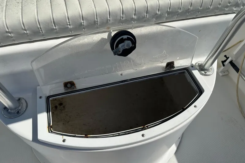 Slide: The Image of 2008 Dusky 278 Center Console boat storage compartment with open lid and seating. - 33