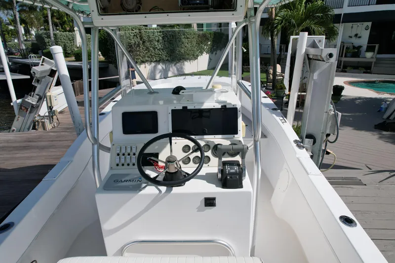 Slide: The Image of 2008 Dusky 278 Center Console boat with modern navigation equipment and steering wheel. - 8