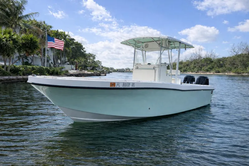 The Image of 2008 Dusky 278 Center Console boat on calm water, American flag in background. - 0