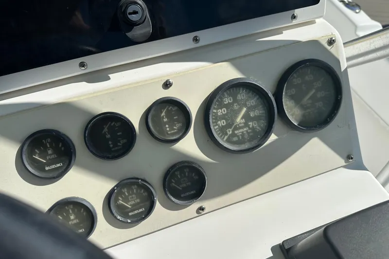 Slide: The Image of Dashboard of 2008 Dusky 278 Center Console boat with Suzuki gauges. - 10