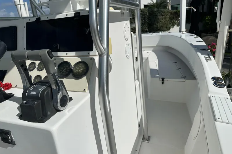 Slide: The Image of 2008 Dusky 278 Center Console boat interior with control panel and seating area. - 13