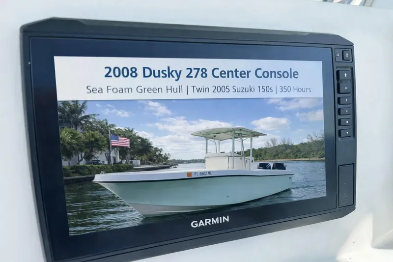 Slide: The Image of 2008 Dusky 278 Center Console boat with sea foam green hull displayed on Garmin screen. - 15