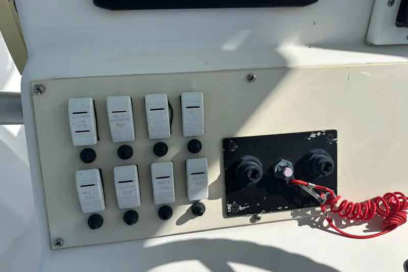 Slide: The Image of Control panel of a 2008 Dusky 278 Center Console boat with switches and wiring. - 16